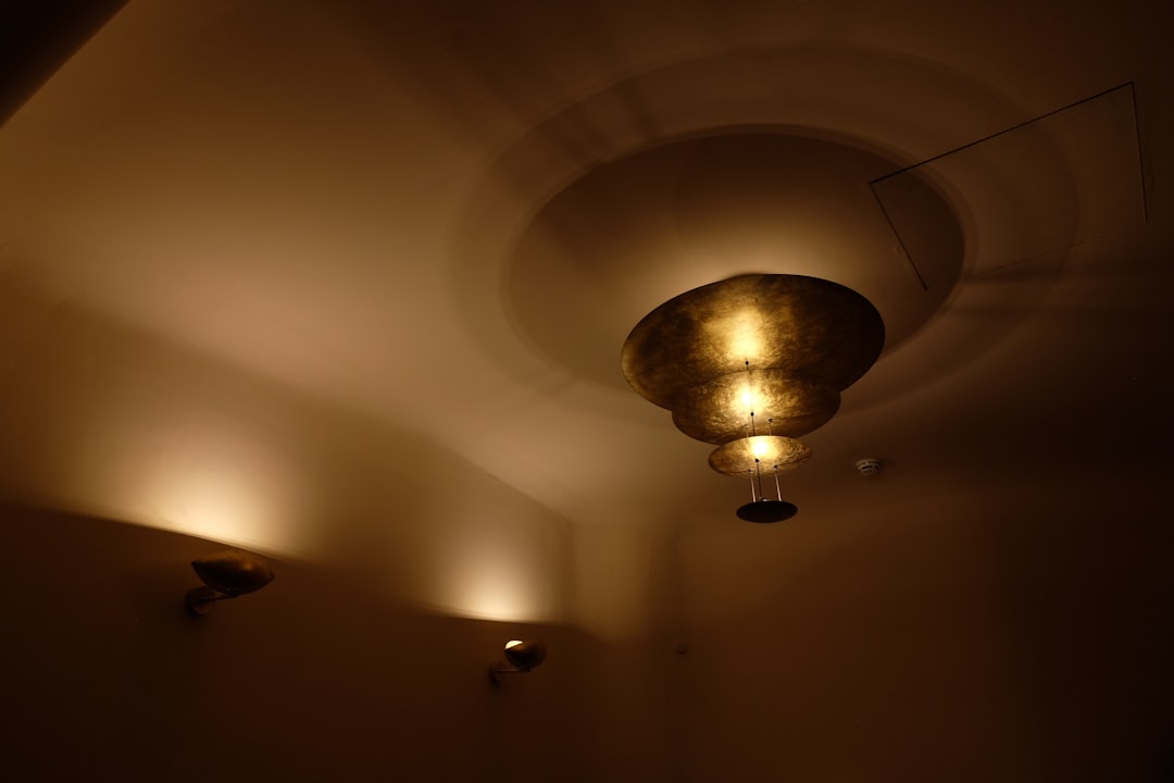 a-dimly-lit-room-with-three-lights-on-the-ceiling-gfoqa7gsfdk